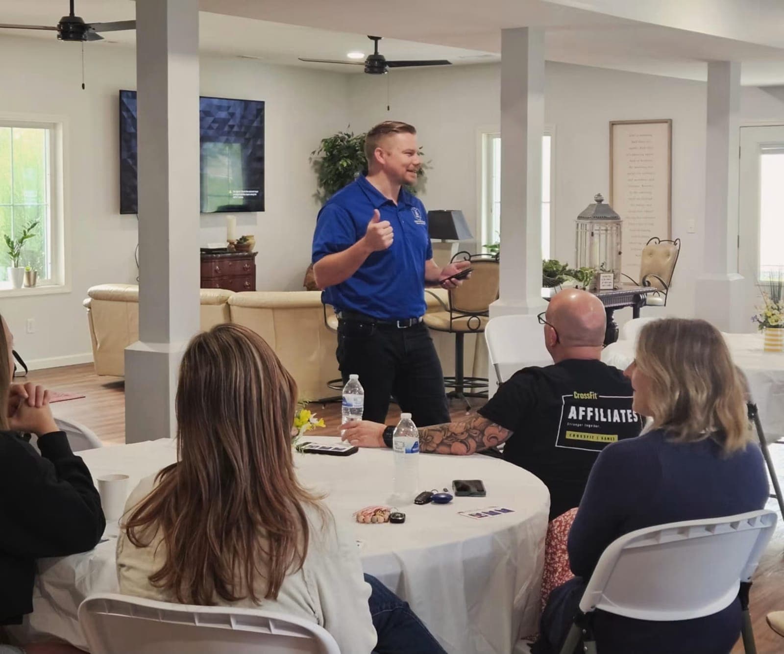 A speaker sharing with members around the tables